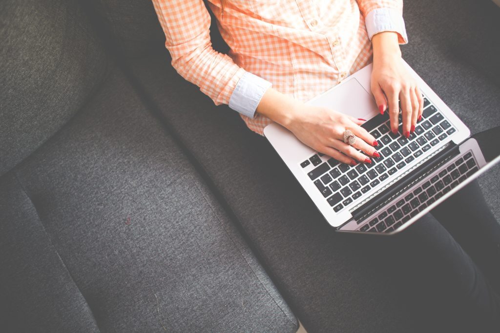 Woman typing on laptop. Image used for blog post "The importance of Blogging"